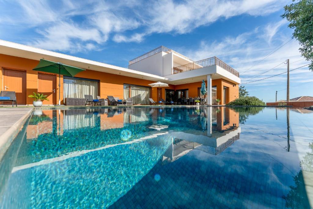 a swimming pool in front of a house at Villa Joya in Almancil