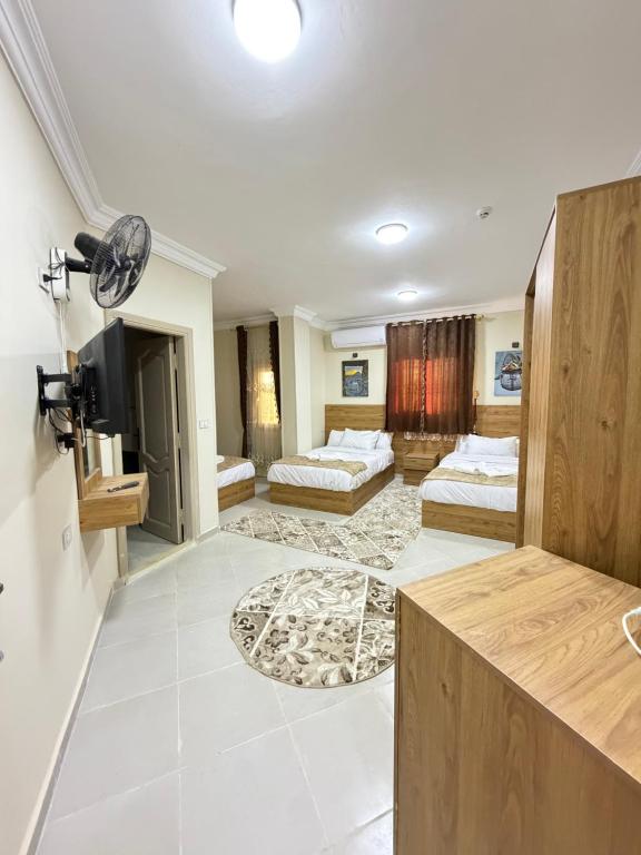 a large room with two beds and a television at Siwa Star Rooms in Siwa