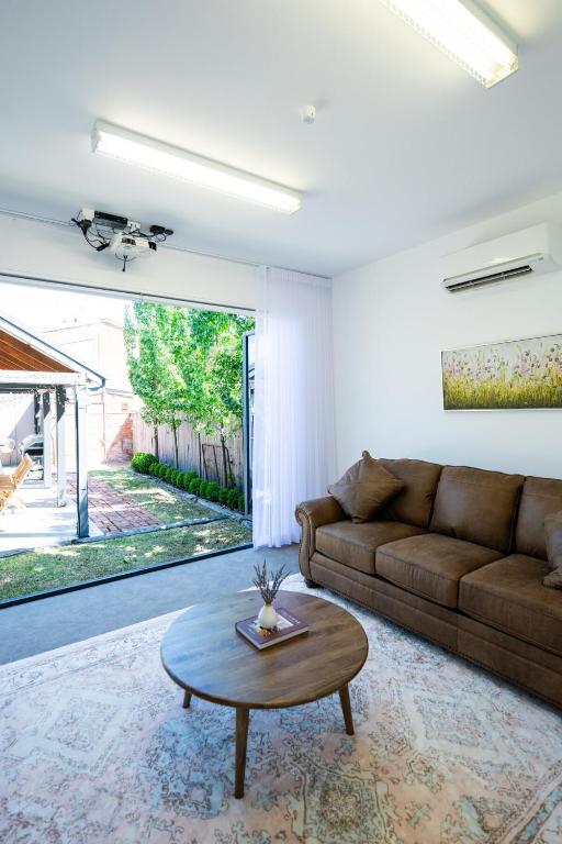 a living room with a couch and a coffee table at Rosewood Terrace in Bathurst