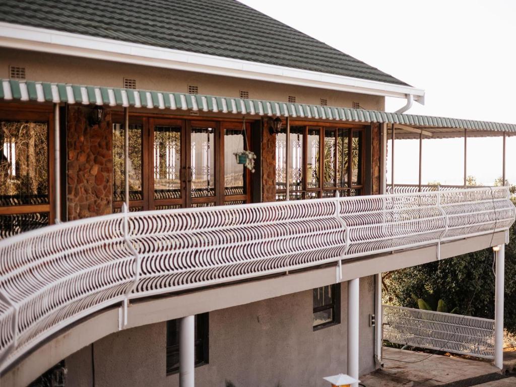 a building with a bridge in front of it at Kudu Kopje Lodge in Kroondal