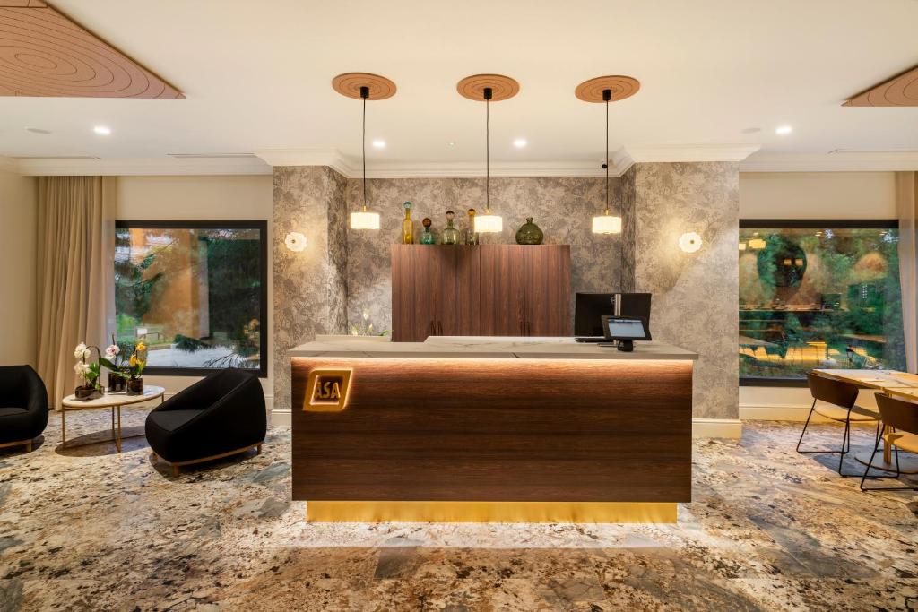 a hotel lobby with a reception desk and chairs at ASA Molina Plaza in Molina de Segura