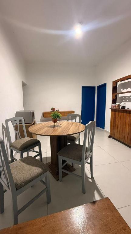 a dining room with a wooden table and chairs at Casa Colina in Ouro Preto