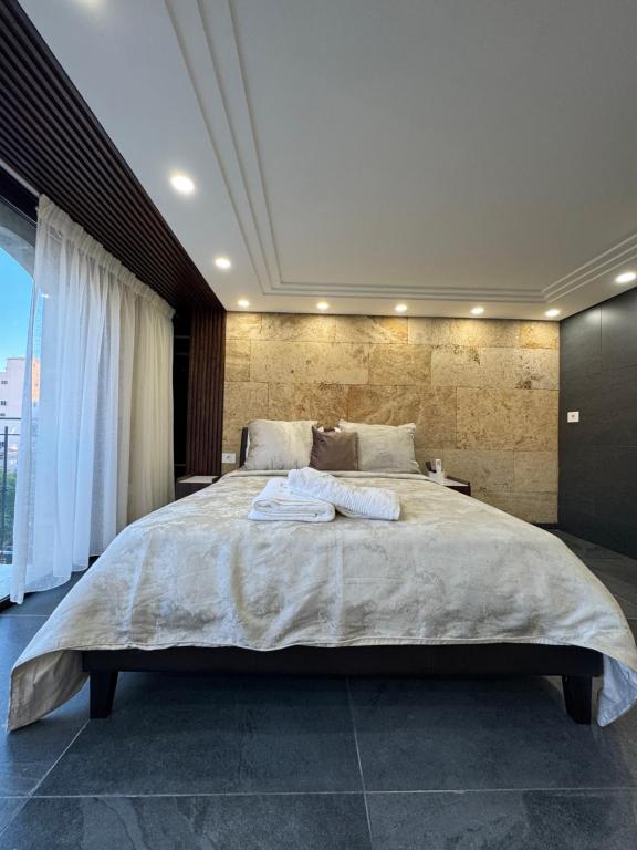 ein Schlafzimmer mit einem großen Bett, auf dem zwei Handtücher liegen in der Unterkunft B in Byblos in Byblos