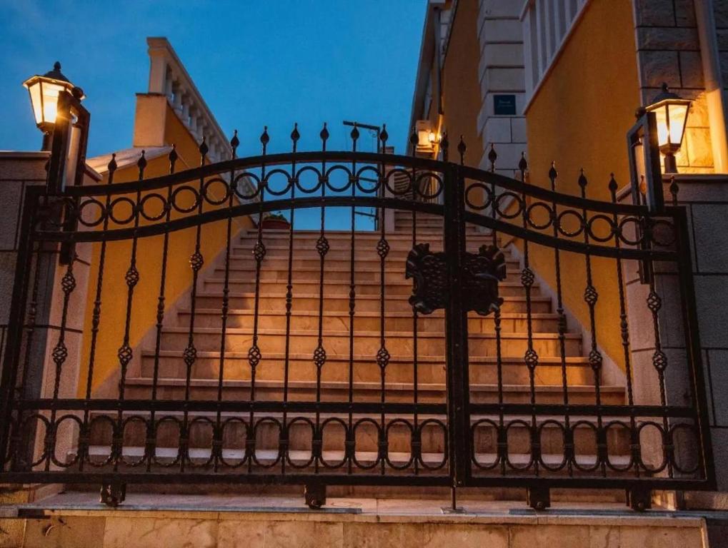 a set of stairs with a wrought iron fence at Apartmani OREBIĆ in Orebić