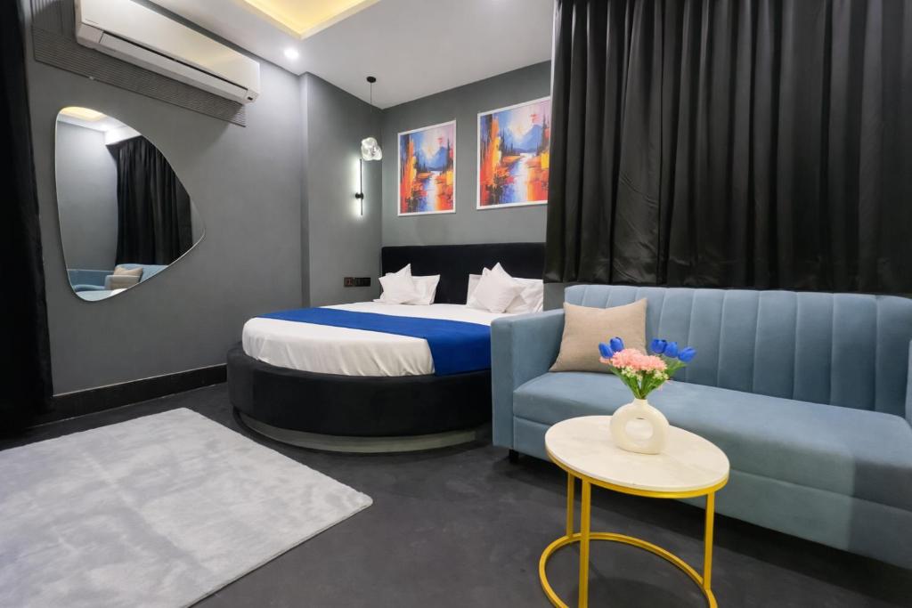 a hotel room with a bed and a couch at The Boutique Studio Near Green Park Delhi- By ACESTAYZ in New Delhi