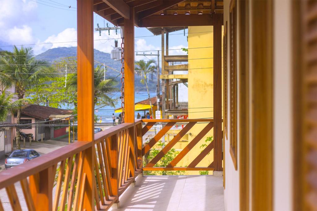 a balcony of a building with a view of the ocean at Balangan Flats in Ubatuba