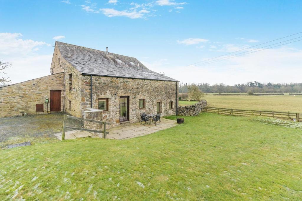 an old stone barn in a field of grass at 2 Bed in Ingleton oc-h34470 in Ingleton