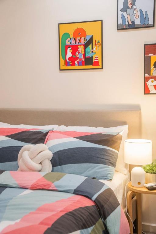 a bedroom with two beds and a picture on the wall at Puddings Home Compact Apartment State Library in Melbourne
