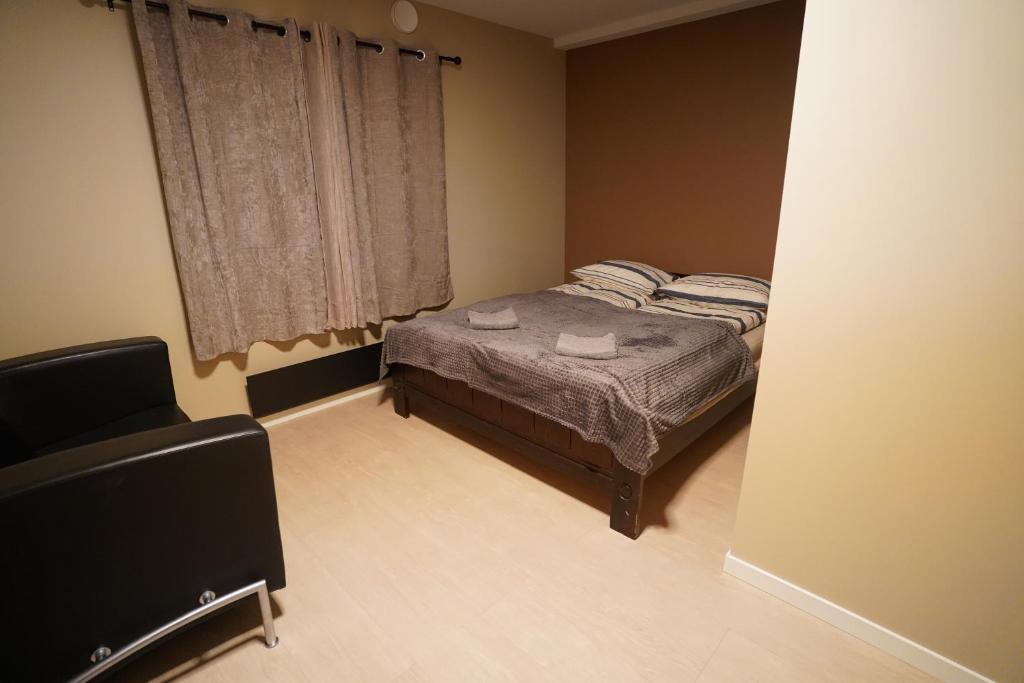 a small bedroom with a bed and a window at Cherry Rooms in Tromsø
