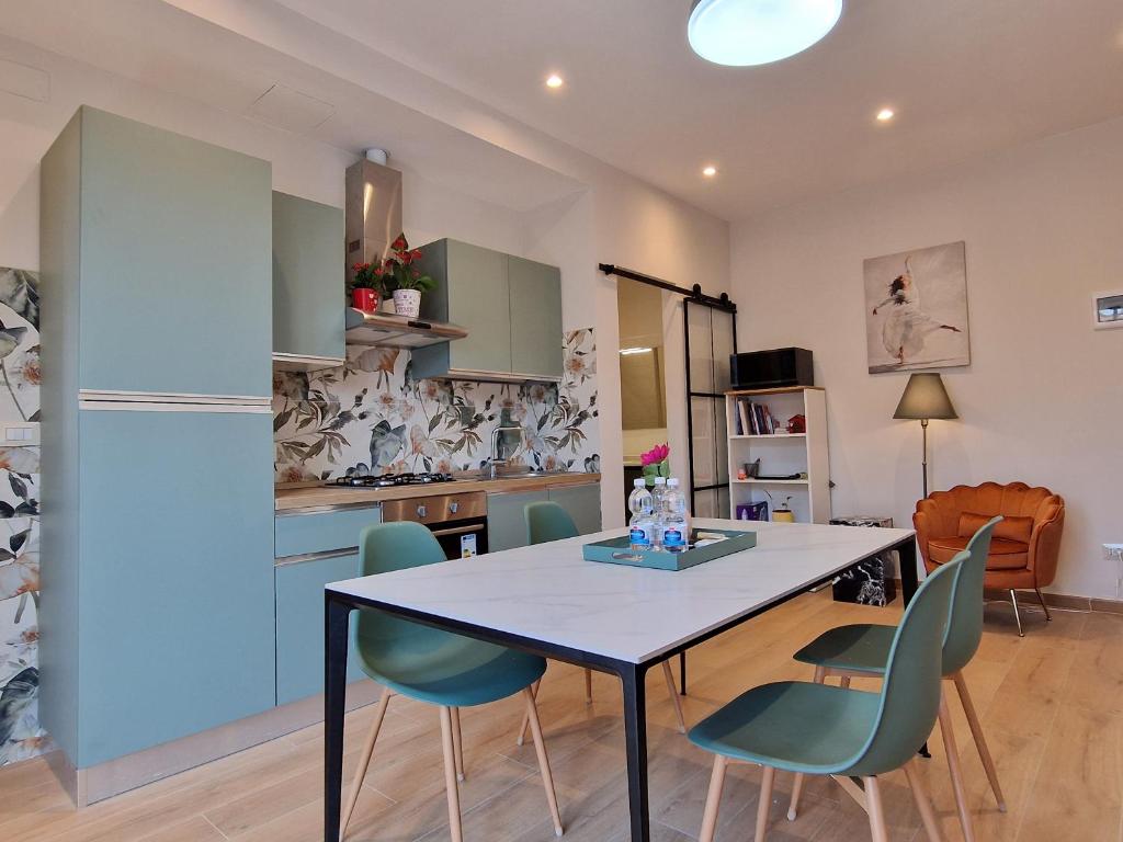 a kitchen with a dining room table and chairs at Dolce 2 bedrooms Apartment Milano 2mins to Rho Fiera & 25mins to Duomo Centre & 100m to Metro in Pero