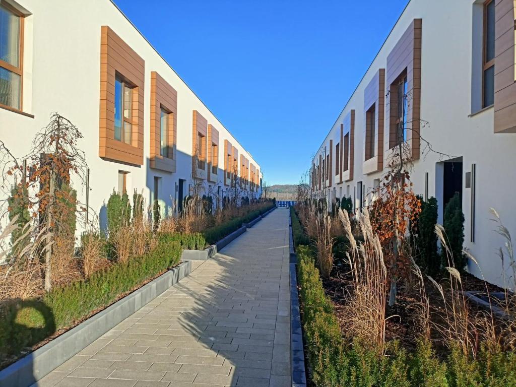 a walkway between two buildings on a street at Przystań Nadole in Nadole