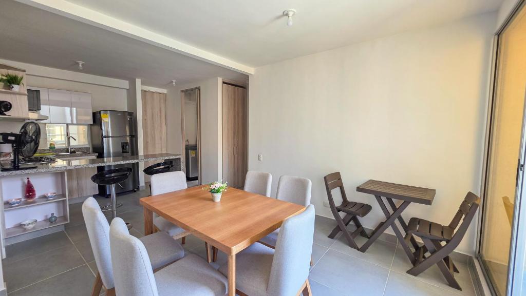 a kitchen and dining room with a table and chairs at Capriella, Serena Del Mar in Cartagena de Indias