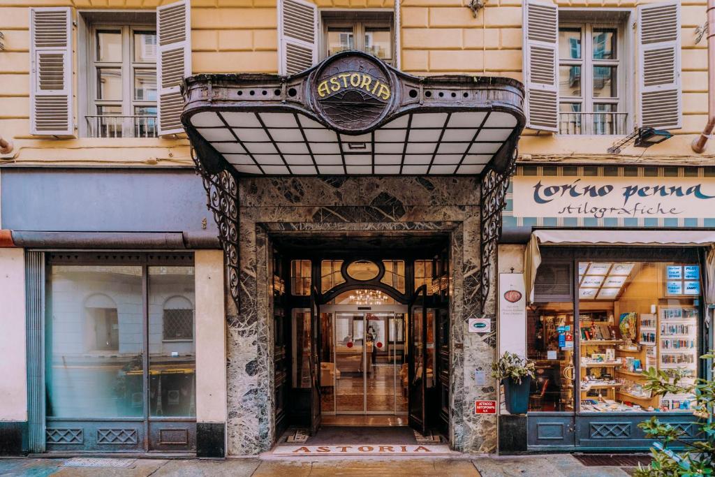 a store front of a building with a sign above the door at Hotel Astoria in Turin