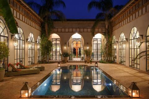 a large building with a pool in the middle of it at Daba Village in Marrakesh