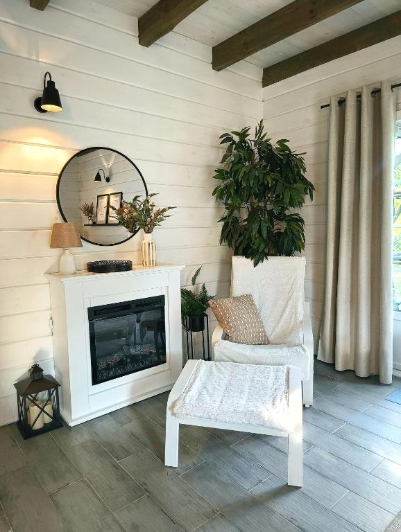 a living room with a fireplace and a mirror at Żółte Drzwi Sucha Rzeczka in Sucha Rzeczka