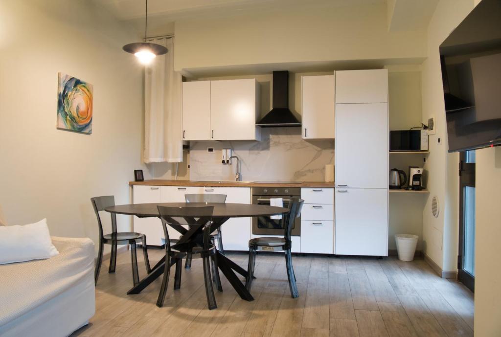 a kitchen and dining room with a table and chairs at Cozy home away in Lecco