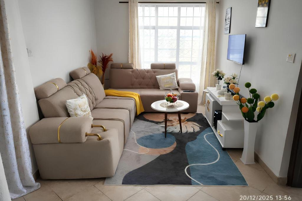 a living room with a couch and a table at Nanako Comforts in Kitengela 
