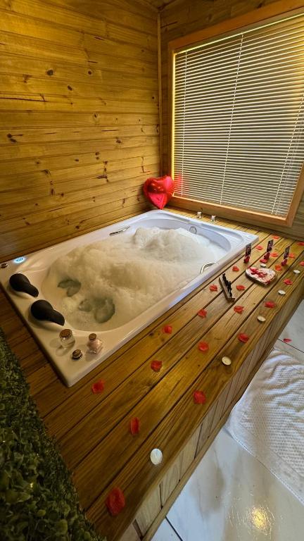 a jacuzzi tub in a wooden room at Pousada dos Canyons - chalé 01 in Praia Grande
