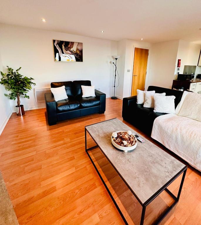 a living room with a couch and a table at Waters View in Edinburgh