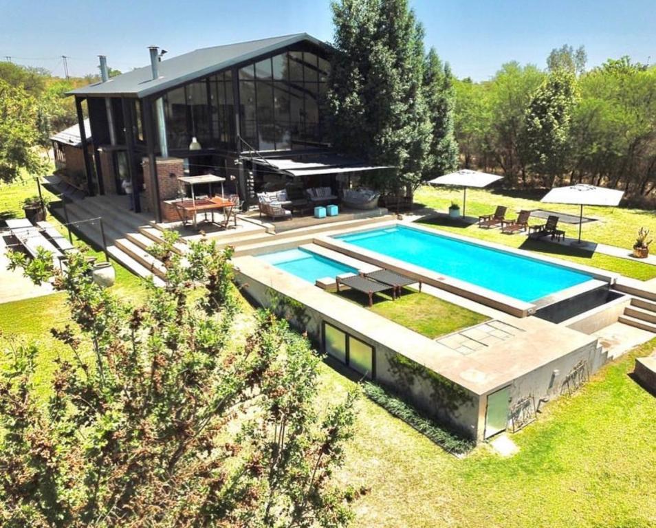 a house with a swimming pool in front of it at Marble Nights Damoi Parys in Vosburg