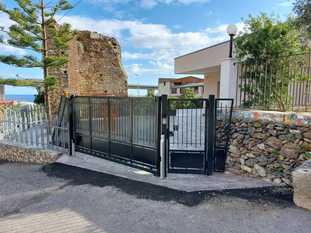 a black metal gate in front of a building at Antico Pozzo in Badia