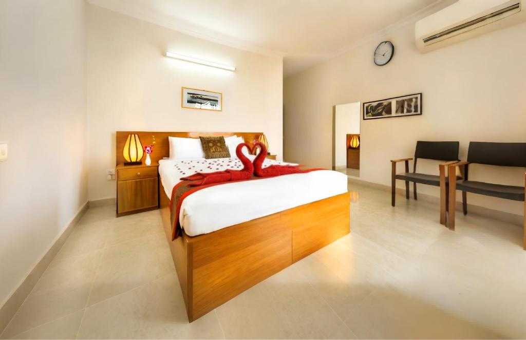 a bedroom with a bed with a red towel on it at Dhaka Golden Inn - Banani'Lakeside in Dhaka