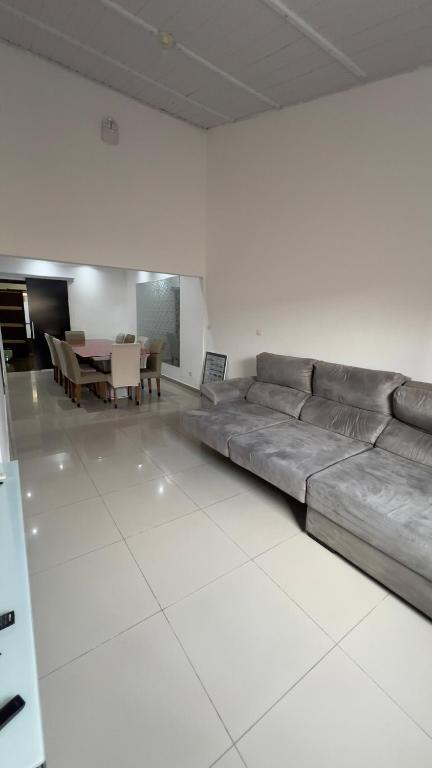 a living room with a couch and a table at JK Casa de Praia in Ilha Comprida