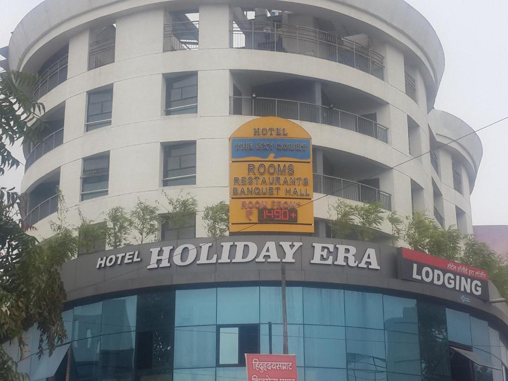un edificio de hotel con un cartel para un brahma de vacaciones en Hotel Holiday Era, en Aurangabad