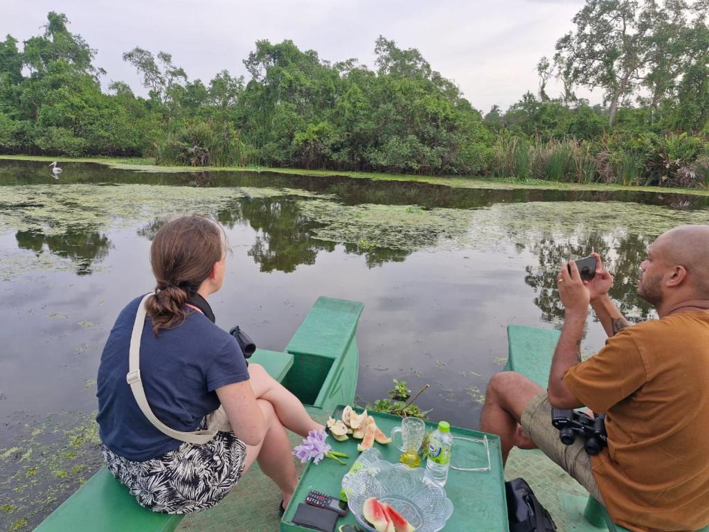 a group of people sitting on a boat in the water at Long Beach Homestay in Tangalle