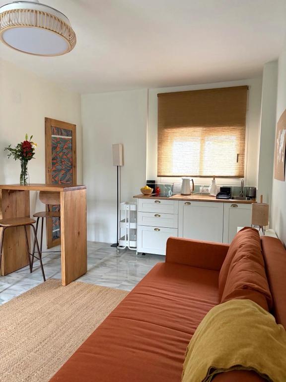 a living room with a couch and a kitchen at Studio-Guest House with Jacuzzi Spa and Sauna in Espartinas