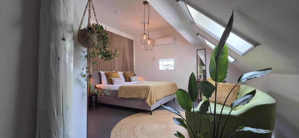 a bedroom with a bed and a potted plant at B&B Grolloo in Grolloo