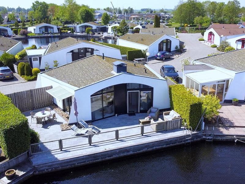 an aerial view of a house next to the water at Aquaronde 117 in Lemmer