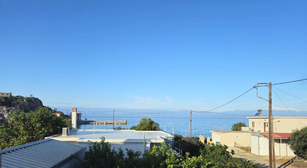 a view of the ocean from the roofs of houses at Mary's apartment Elaia 3 in Elia Laconias