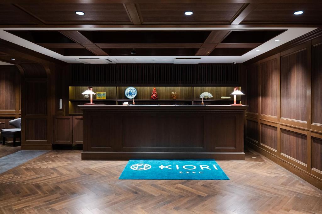 a hotel lobby with a reception desk and a blue rug at KIORI Exec Muromachi in Kyoto