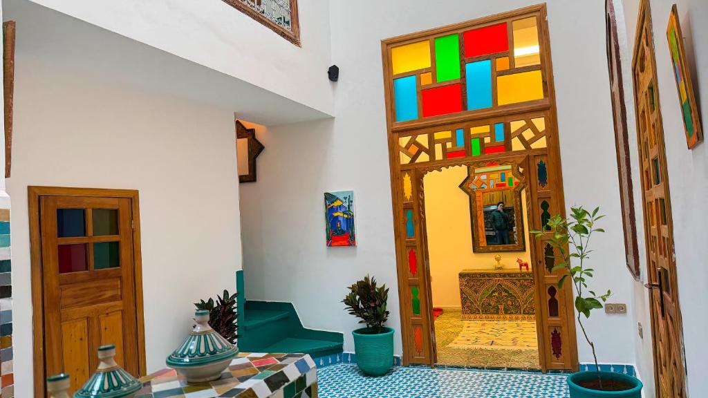 a room with a colorful door and a table at Dar Fayrouz in Fez