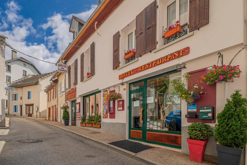 a street in a small town with buildings at Hôtel du Centre in Villard-de-Lans