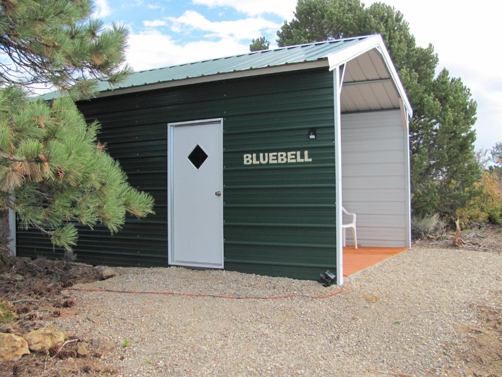 a green garage with a white door with the word builer at Bluebell Cabin, Glamour Cabin Camping, Stunning Night Sky in Monticello