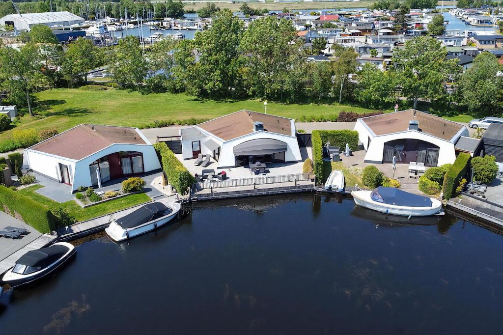 an aerial view of a house with boats in the water at Aquaronde 093 in Lemmer