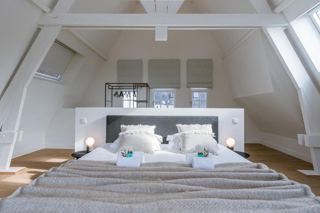 a large bedroom with a large bed with white pillows at Bright Duplex near Antwerp Cathedral in Antwerp
