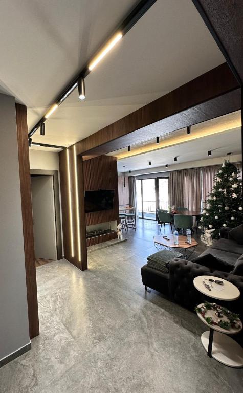 a living room with a couch and a christmas tree at X2 4Rest Bakuriani in Bakuriani