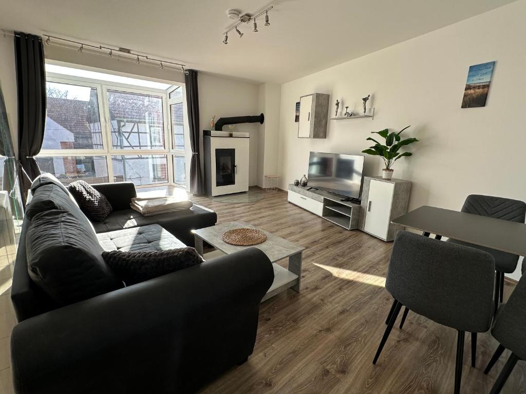 a living room with a couch and a tv at Ferienhaus Weimarer Land in Berlstedt