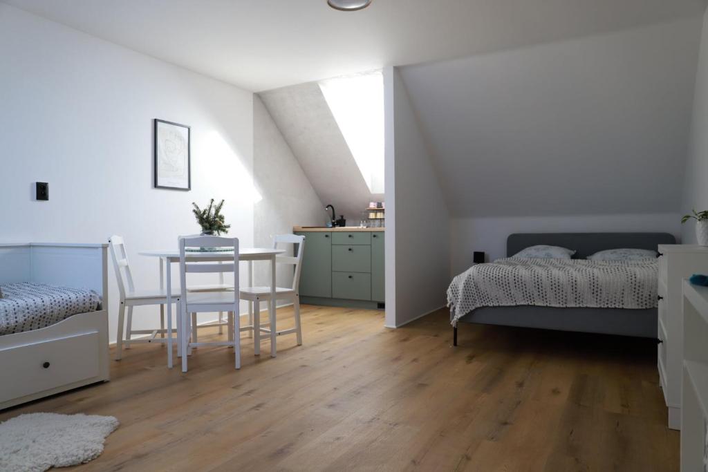 a bedroom with a bed and a table and chairs at Šťastná 118 in Sněžné