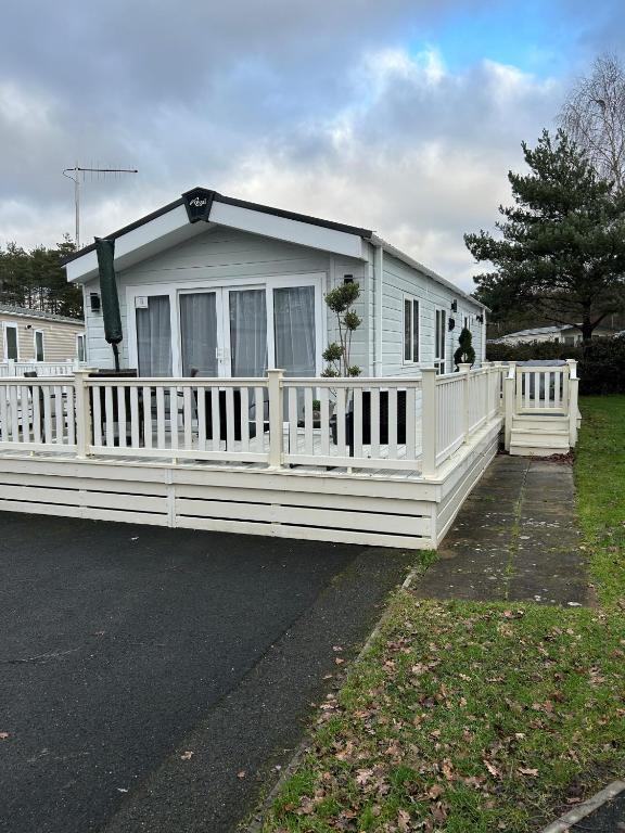 a white house with a white fence at Tulip 10, Oakdene Forest Park , passes included in Saint Leonards