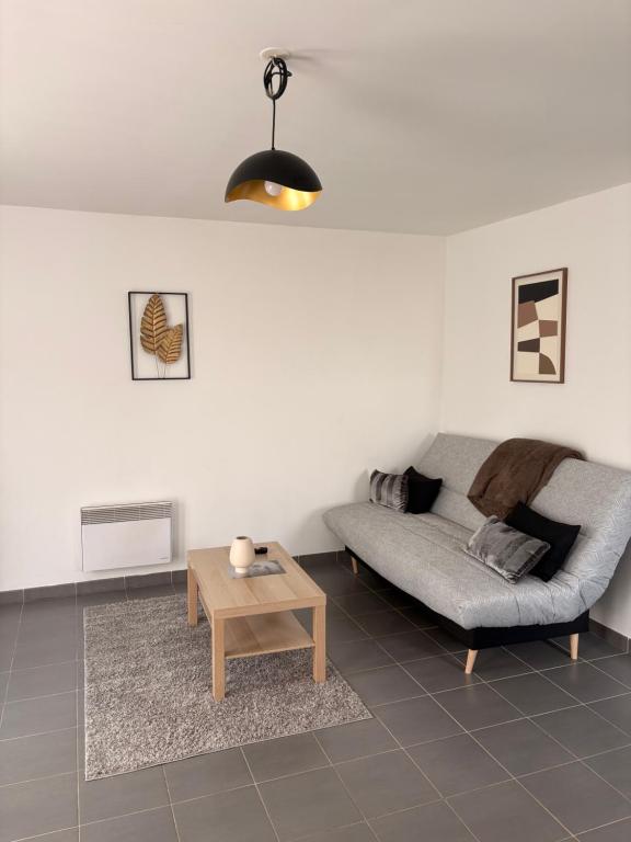 a living room with a couch and a coffee table at Maison entière avec jardin , Proche Bordeaux, Rocade et Arkéa Arena in Bouliac