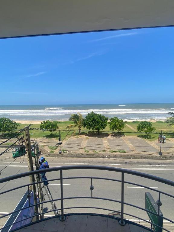 a person standing on a lifeguard tower looking at the ocean at Mayura Beach Resort Matara in Matara