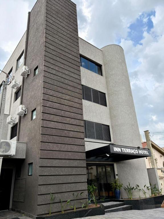 a building with a sign on the side of it at INN TERRAÇO Hotel in Mirandópolis