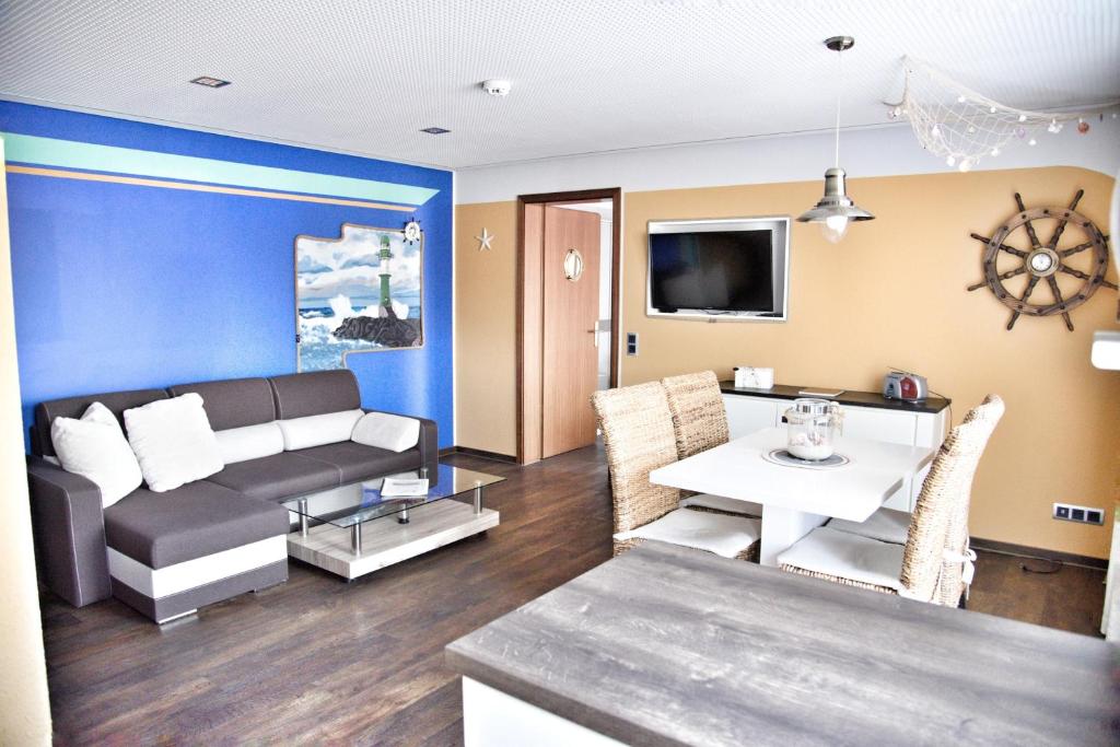 a living room with a couch and a table at Lagunenstadt am Haff - Fewo 72 Flip in Ueckermünde