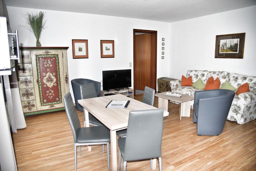 a living room with a table and chairs and a couch at Lagunenstadt am Haff - Fewo 125 Yarn in Ueckermünde