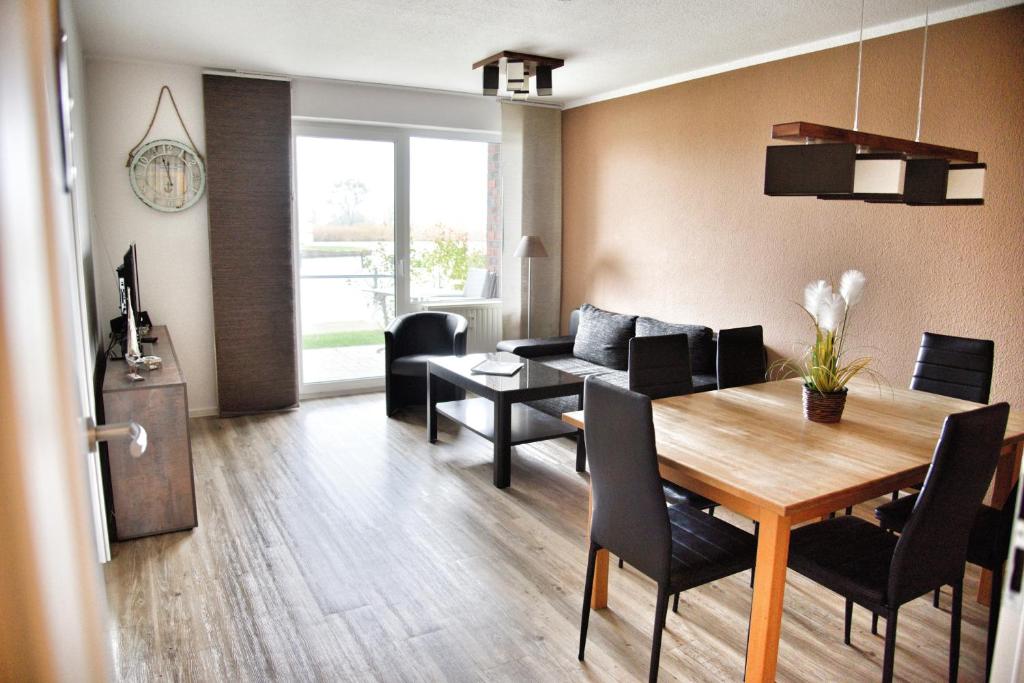a living room with a table and a dining room at Lagunenstadt am Haff - 119 Marina in Ueckermünde
