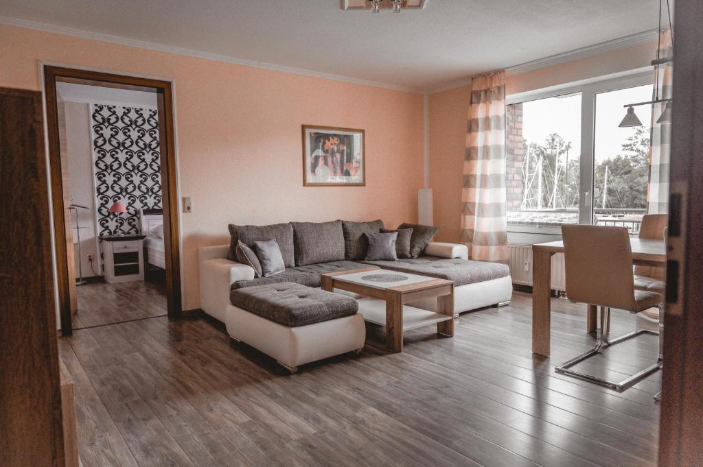 a living room with a couch and a table at Lagunenstadt am Haff - 146 Oberlicht in Ueckermünde